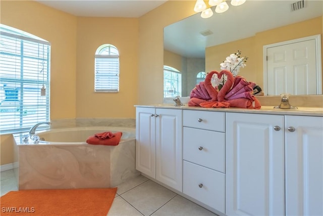 bathroom featuring tile patterned flooring, vanity, and a washtub