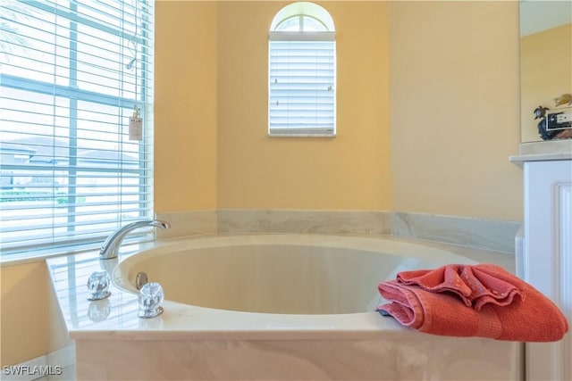 bathroom with a tub to relax in