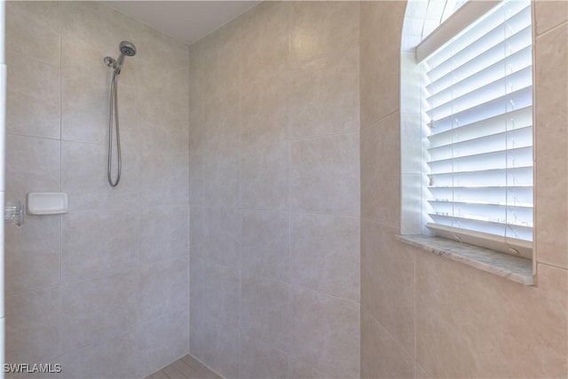 bathroom with tiled shower