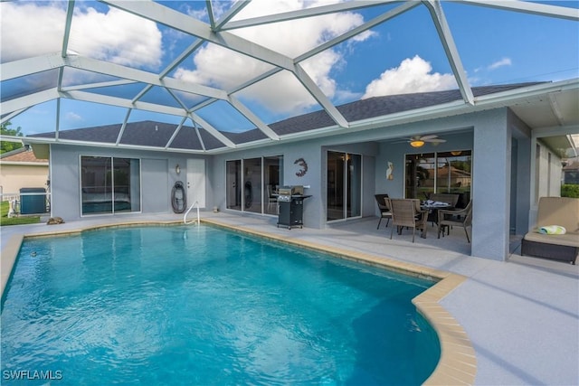 view of pool with central AC unit, ceiling fan, a patio, and glass enclosure