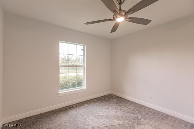 carpeted empty room featuring a wealth of natural light and ceiling fan