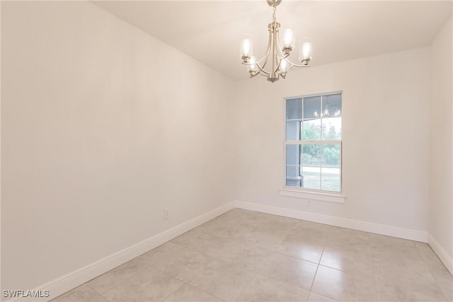 tiled empty room with a chandelier