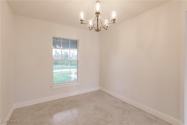 spare room with light tile patterned floors and a notable chandelier