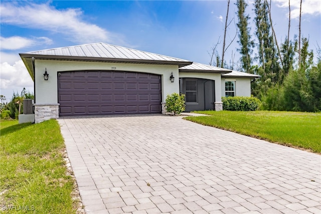 ranch-style home with a front yard, a garage, and cooling unit