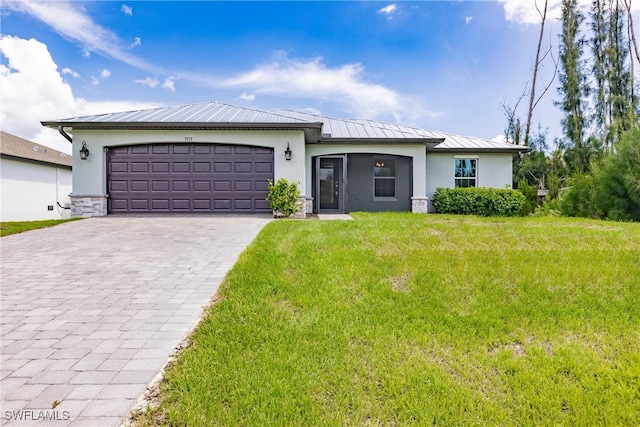 view of front facade with a front yard and a garage