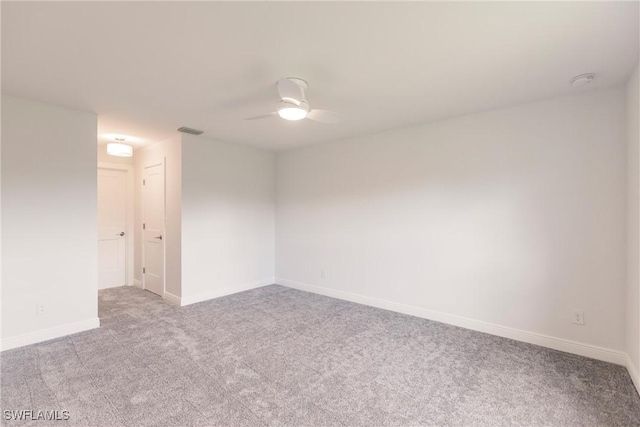 spare room with ceiling fan and light colored carpet