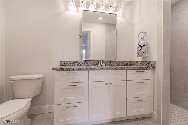 bathroom with tiled shower, tile patterned floors, vanity, and toilet