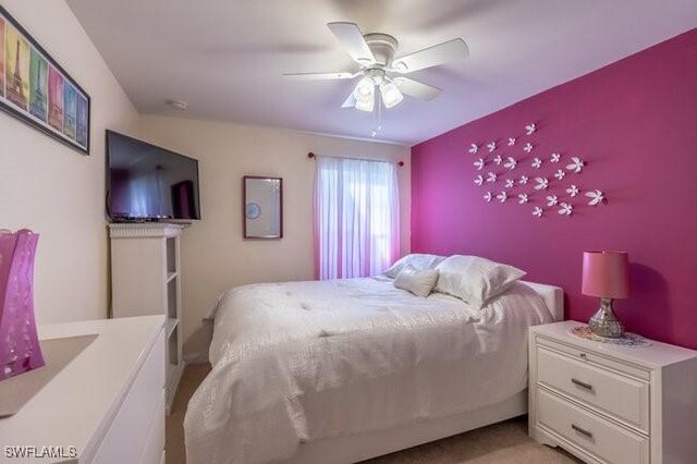 carpeted bedroom featuring ceiling fan