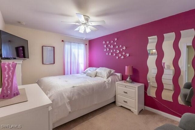 bedroom with ceiling fan and light carpet