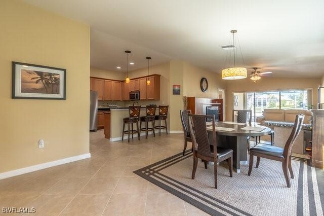 tiled dining area featuring ceiling fan