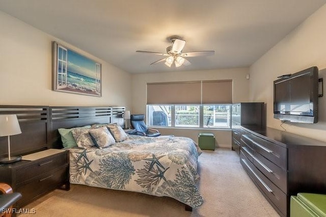 bedroom featuring ceiling fan and light carpet