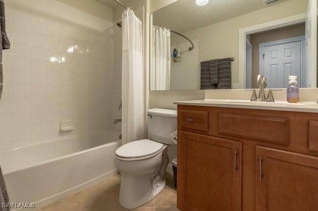 full bathroom featuring tile patterned flooring, shower / bath combo, vanity, and toilet