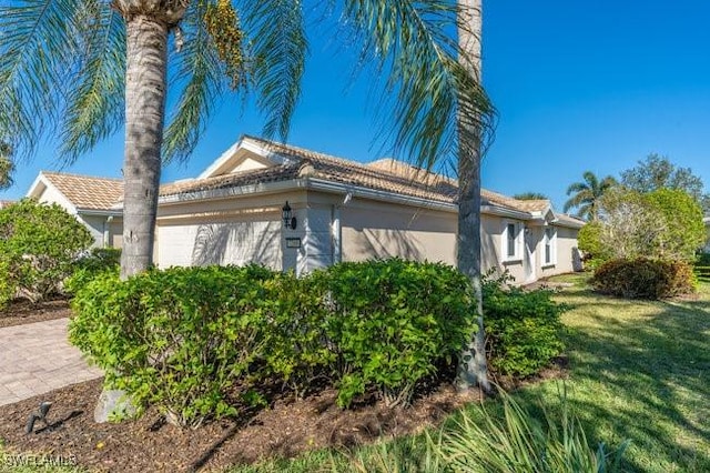 view of side of home featuring a lawn