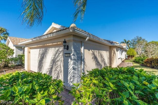 exterior space featuring stucco siding and a garage