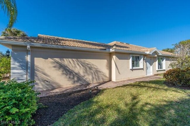 view of property exterior with a yard