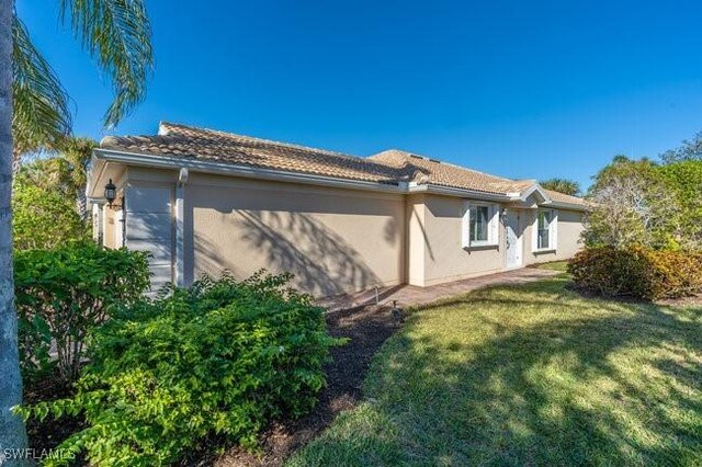 view of property exterior with a yard