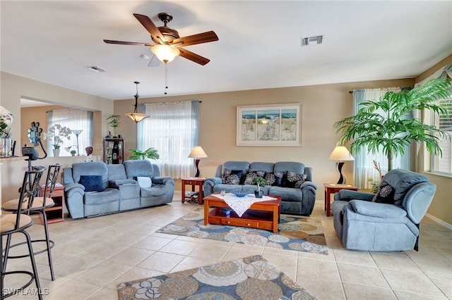 tiled living room with ceiling fan