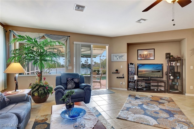 living room featuring light tile patterned floors and ceiling fan