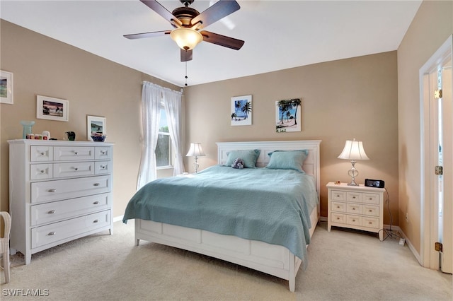 bedroom featuring ceiling fan and light carpet