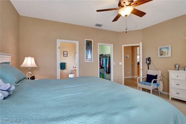 carpeted bedroom featuring a spacious closet, a closet, and ceiling fan