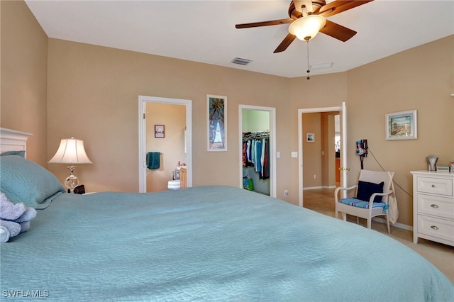 8040 Liriope Loop, Lehigh Acres, FL 33972 - bedroom featuring light carpet, a walk in closet, ceiling fan, a closet, and ensuite bathroom