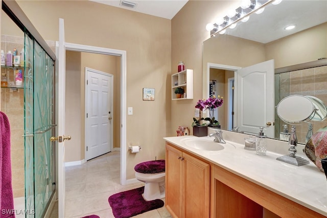 bathroom featuring tile patterned flooring, vanity, and a shower with shower door