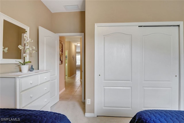 8040 Liriope Loop, Lehigh Acres, FL 33972 - bedroom with a closet, baseboards, light colored carpet, and light tile patterned floors