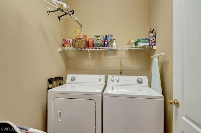 clothes washing area with washing machine and dryer