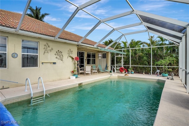 view of swimming pool featuring a lanai