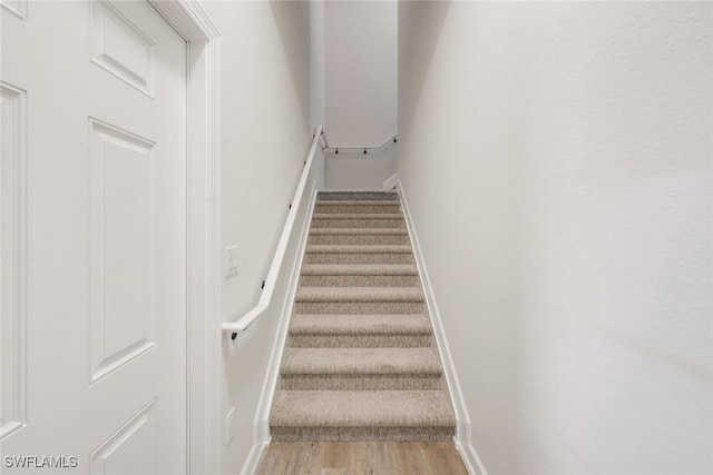 stairs with hardwood / wood-style flooring