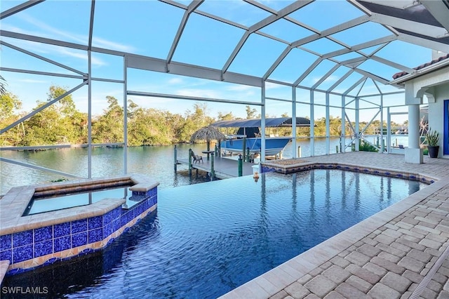 view of pool with a water view, an in ground hot tub, a lanai, and a dock