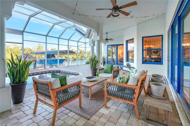 sunroom / solarium with a water view and ceiling fan