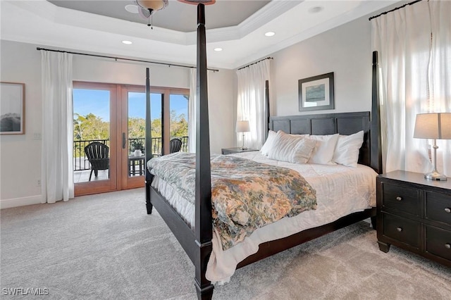 bedroom featuring light carpet, access to outside, a raised ceiling, and french doors