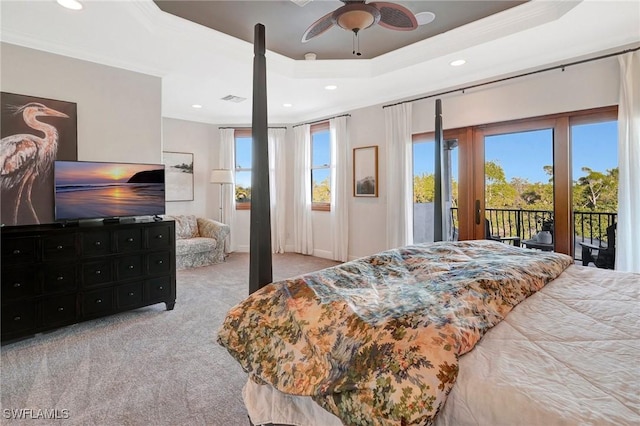 bedroom featuring light carpet, a tray ceiling, access to outside, and ornamental molding