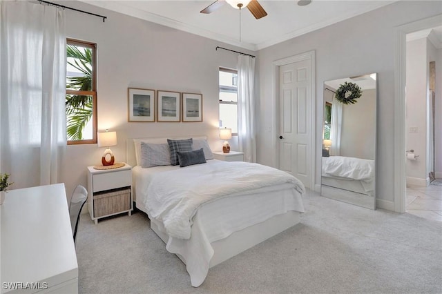 carpeted bedroom with crown molding and ceiling fan