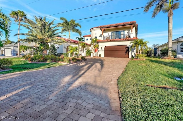 mediterranean / spanish home featuring a balcony and a front yard