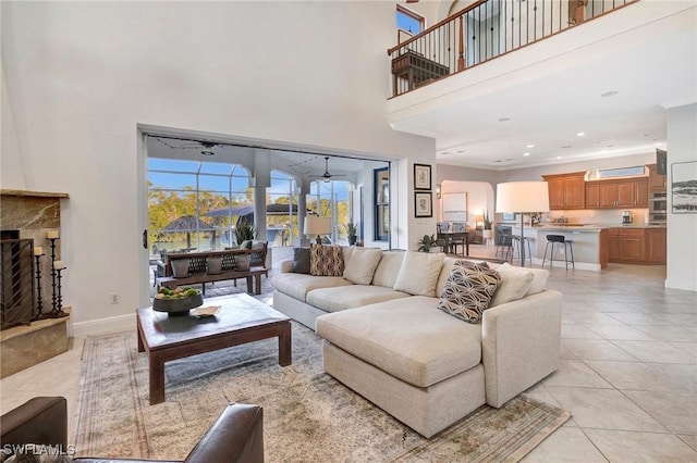 living room featuring light tile patterned floors and a high ceiling