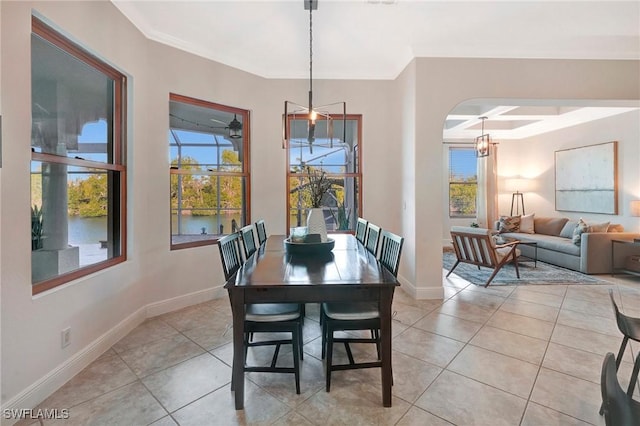 dining space featuring coffered ceiling, light tile patterned floors, crown molding, and a healthy amount of sunlight