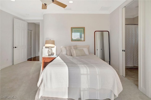 carpeted bedroom featuring crown molding and ceiling fan