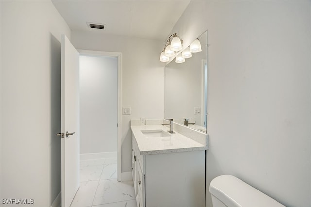 half bathroom with baseboards, visible vents, toilet, marble finish floor, and vanity