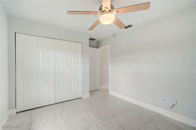 unfurnished bedroom with marble finish floor, a closet, visible vents, and baseboards