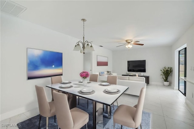 dining space with ceiling fan with notable chandelier, visible vents, and baseboards