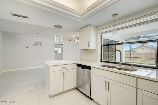 kitchen with a peninsula, marble finish floor, light countertops, stainless steel dishwasher, and a sink