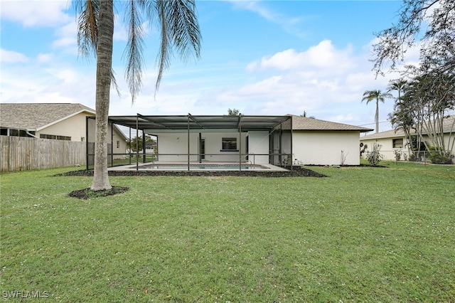 back of house featuring a lawn, a lanai, a fenced in pool, and a fenced backyard