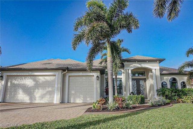 view of front of home with a garage and a front yard