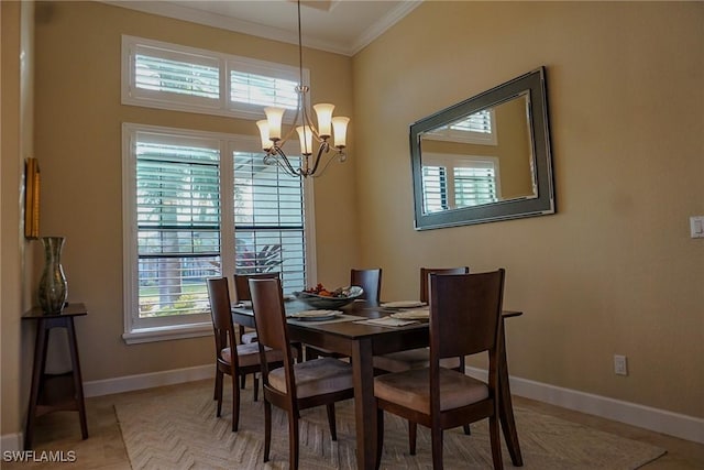 dining space with tile patterned flooring, an inviting chandelier, a wealth of natural light, and crown molding