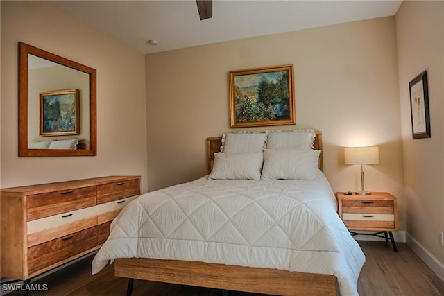 bedroom with hardwood / wood-style flooring and ceiling fan