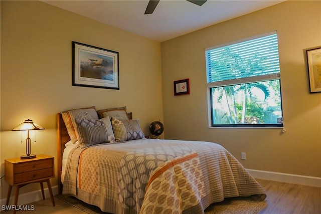 bedroom with light hardwood / wood-style floors and ceiling fan