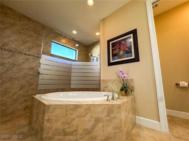 bathroom with shower with separate bathtub and tile patterned floors