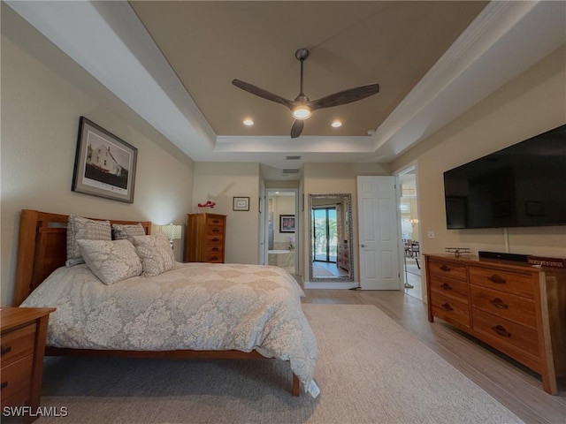 bedroom featuring light wood-type flooring, access to outside, a tray ceiling, ceiling fan, and crown molding